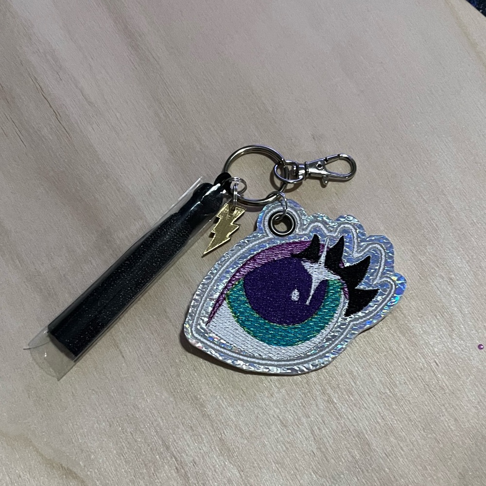 Embroidered Eye Accented laser cut Charm and silk tassel Key Chain purse Charm